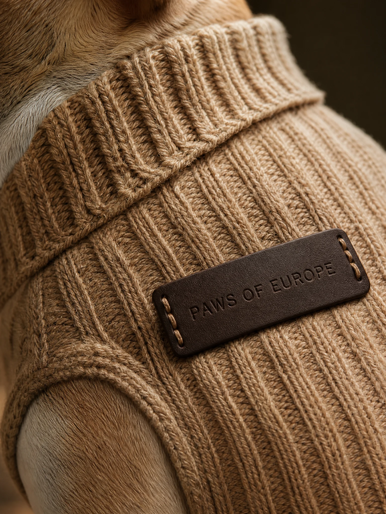 Close-up of merino knit and the Paws of Europe leather label